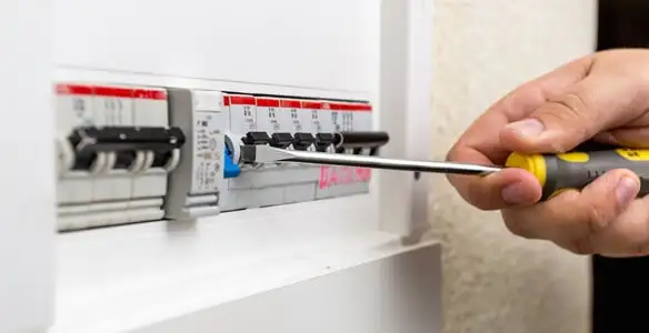 electrical panel upgrade service showing technician adjusting circuit breakers during system upgrade in Mesa, AZ