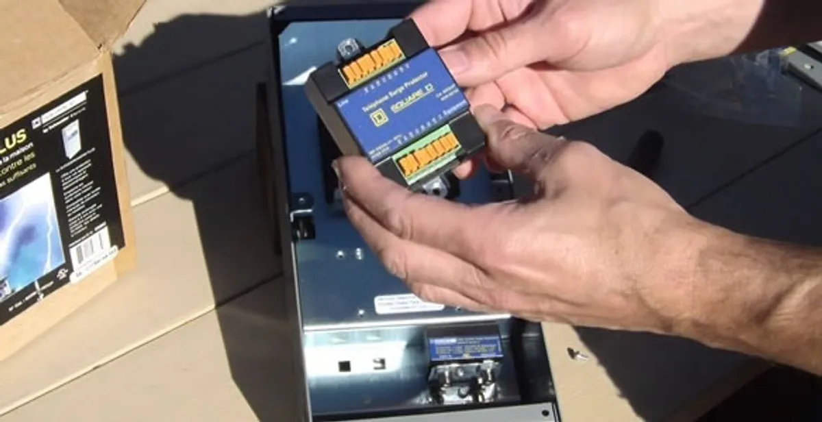 Electrician installing whole home surge protection unit inside main electrical panel in Mesa, AZ
