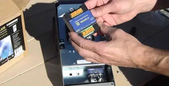 Electrician installing whole home surge protection unit inside main electrical panel in Mesa, AZ