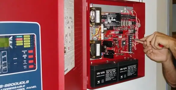 fire alarm installation service showing technician configuring fire alarm control panel in Mesa, AZ