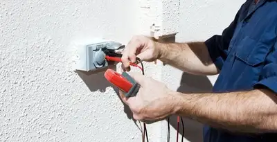 Electrician performing home electrical outlet and wiring inspection in Mesa, AZ