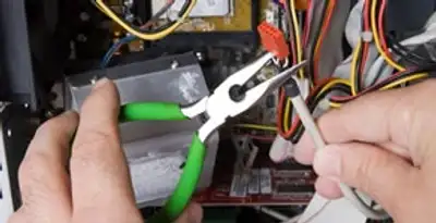 Licensed electrical contractor performing electrical repair with tools in Tempe, AZ