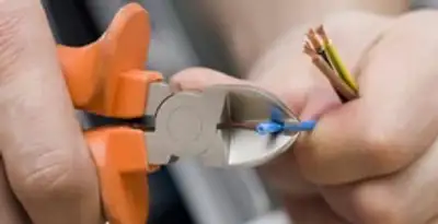 professional electrical services showing precise wire cutting by licensed electricians in Mesa, AZ