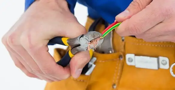 licensed electrician securing electrical wiring with professional tools during service work in Mesa, AZ