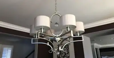 Modern chandelier installation with multiple light fixtures in Mesa, AZ