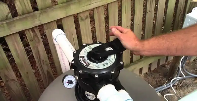 pool pumps service showing professional adjustment of pool pump control system in Mesa, AZ